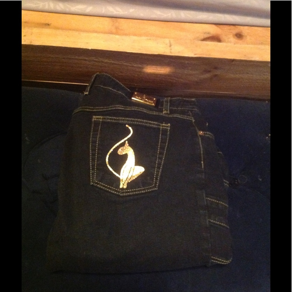 Baby phat blue jeans with gold pocket and design.